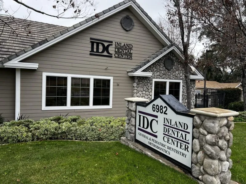 Exterior of Inland Dental Center — gray building with stone sign at 6982